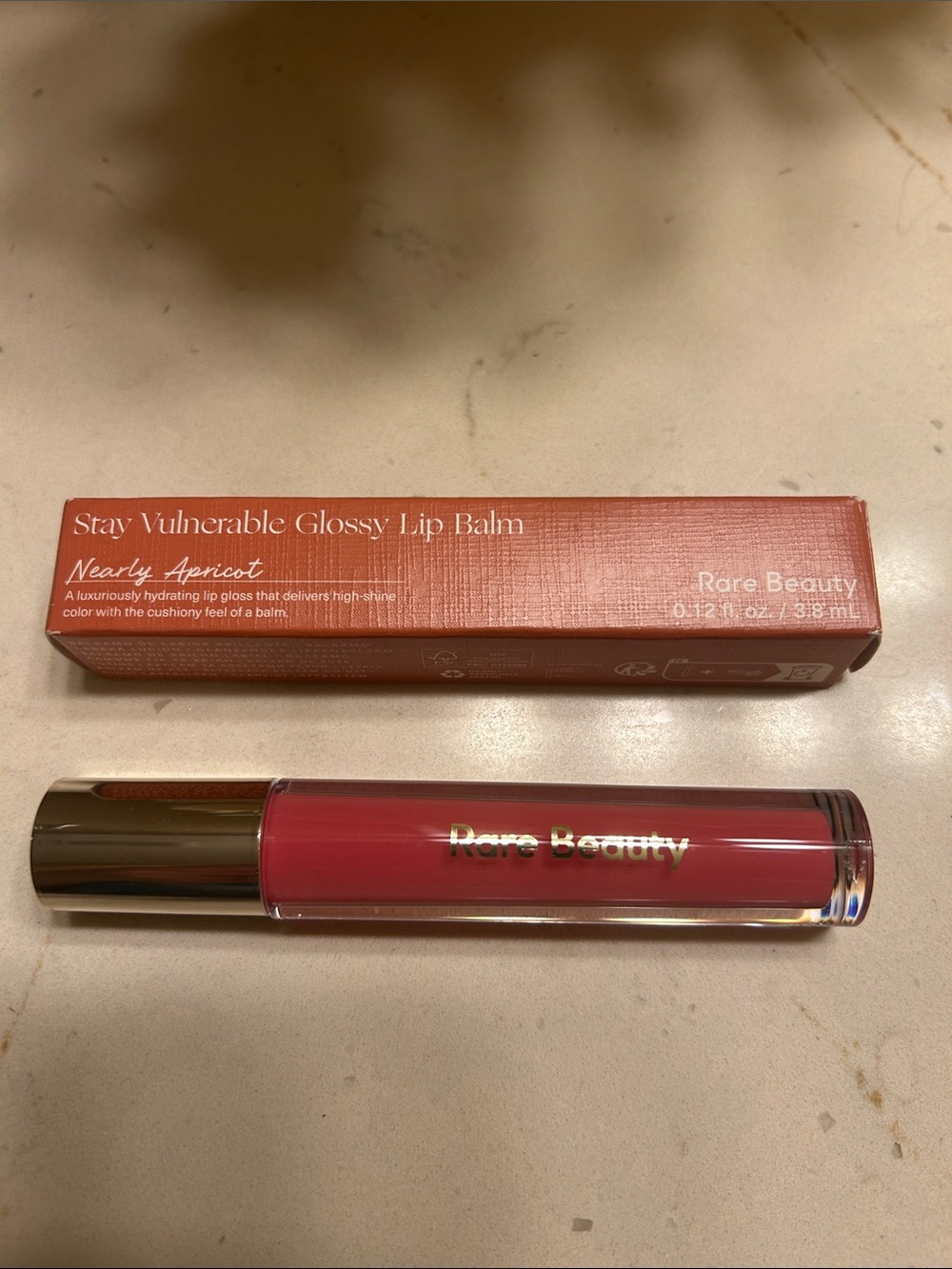 Rare Beauty glossy lip balm shade nearly apricot